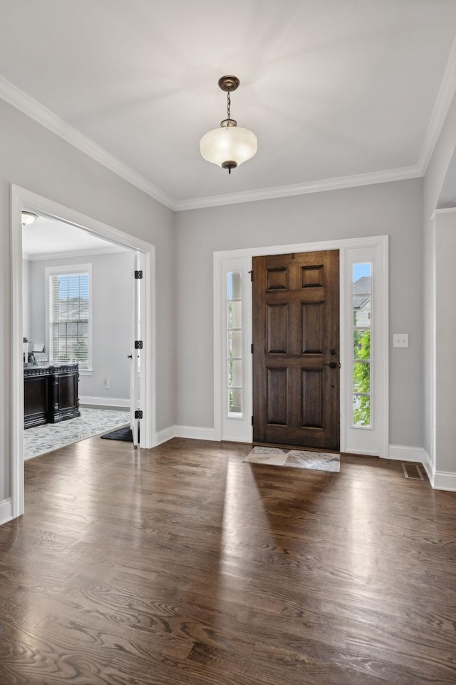 foyer with crown molding and dark hardwood / wood-style floors