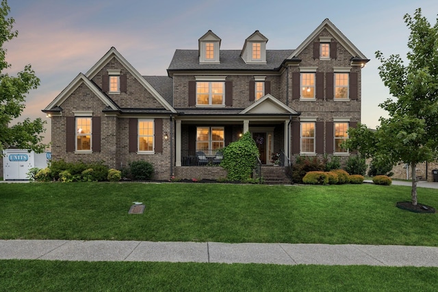 craftsman-style house with a yard and covered porch