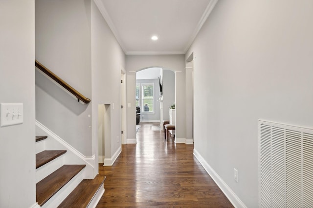 hall featuring ornamental molding and dark hardwood / wood-style flooring