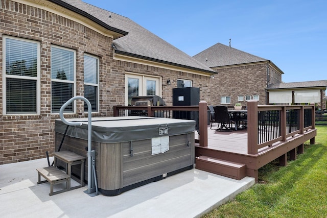 wooden terrace featuring a hot tub