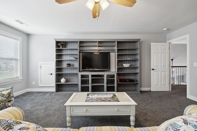 living room with ceiling fan and dark carpet