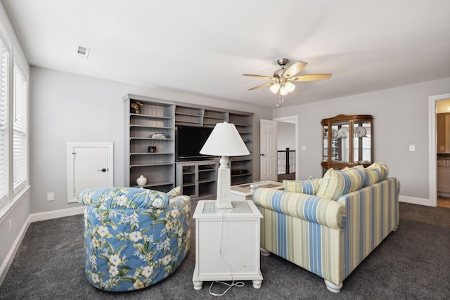 living room with ceiling fan, a healthy amount of sunlight, and dark colored carpet