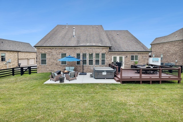 back of house with a patio, a lawn, a wooden deck, outdoor lounge area, and a hot tub