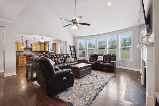 living room featuring decorative columns, high vaulted ceiling, dark hardwood / wood-style floors, and ceiling fan