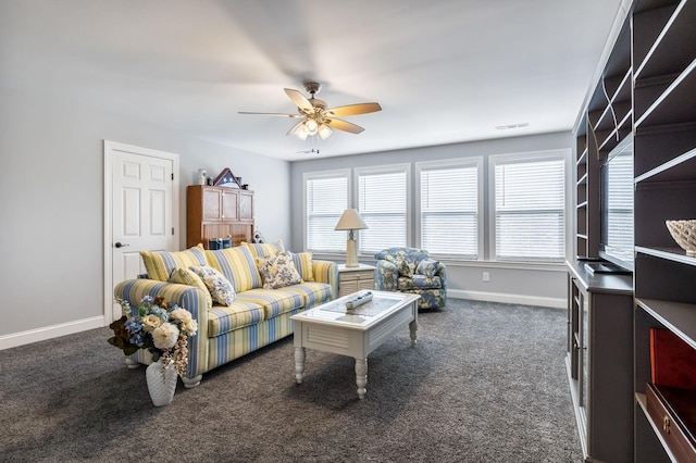 living room with ceiling fan and dark colored carpet