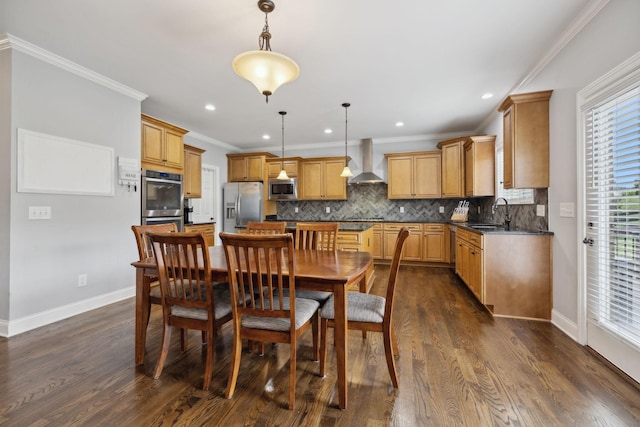 dining room with sink, ornamental molding, and dark hardwood / wood-style floors