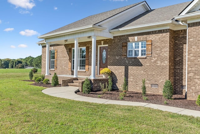 view of front of house featuring covered porch and a front yard