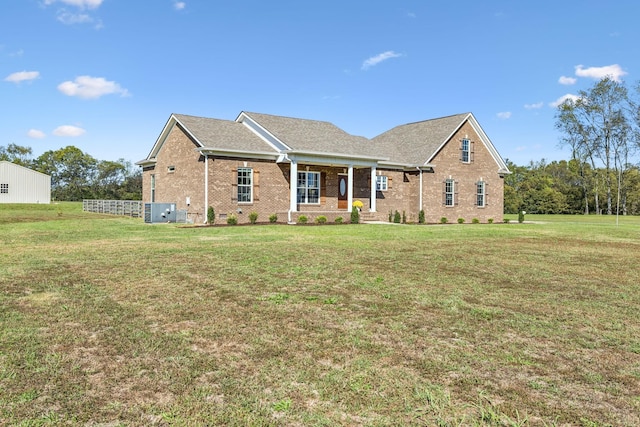 view of front of property with a porch, a front yard, and central air condition unit