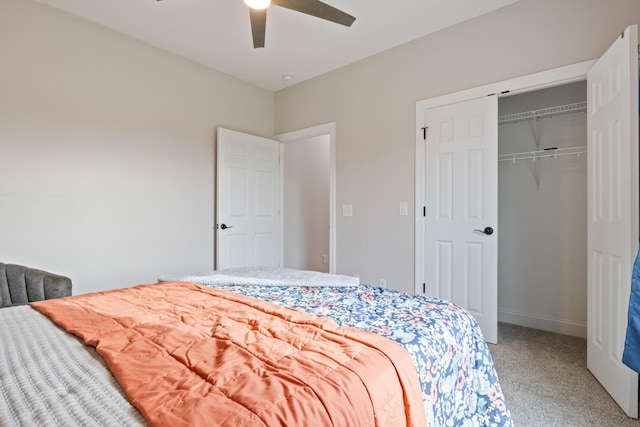 carpeted bedroom with ceiling fan and a closet