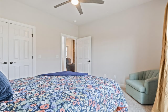 bedroom featuring light carpet, ceiling fan, and a closet