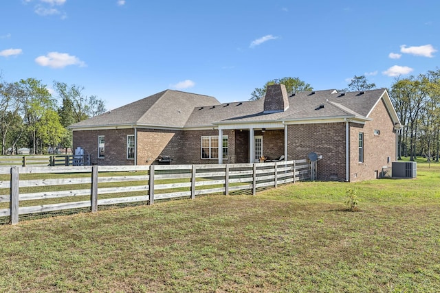 view of front facade featuring central AC unit and a front lawn