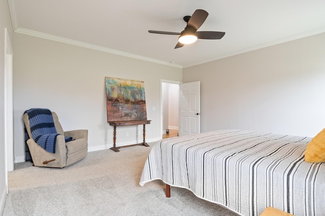 carpeted bedroom with ceiling fan and ornamental molding