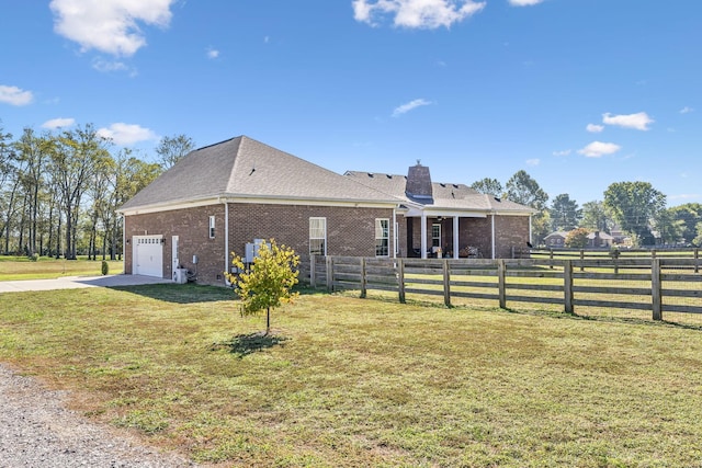 view of home's exterior featuring a garage and a yard