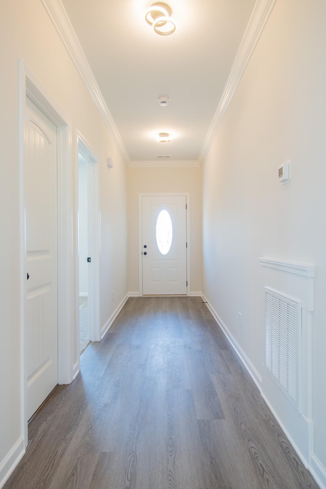 doorway to outside featuring ornamental molding and dark hardwood / wood-style flooring