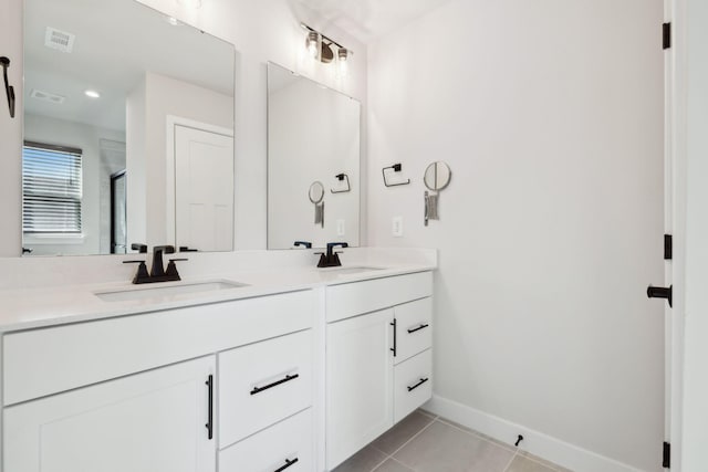 bathroom with vanity, a shower with door, and tile patterned floors