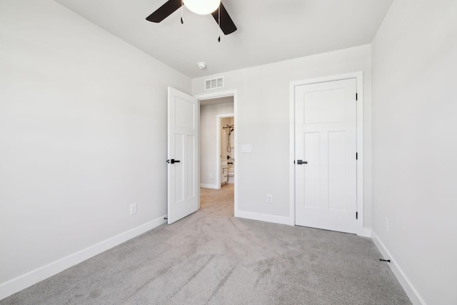 unfurnished bedroom with light colored carpet and ceiling fan