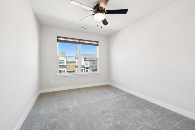 empty room featuring carpet floors and ceiling fan