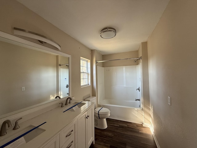 full bathroom featuring hardwood / wood-style flooring, vanity, tub / shower combination, and toilet