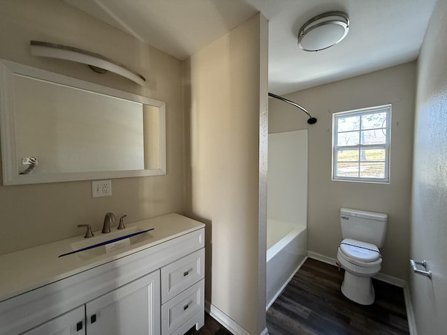 full bathroom with bathtub / shower combination, vanity, toilet, and wood-type flooring