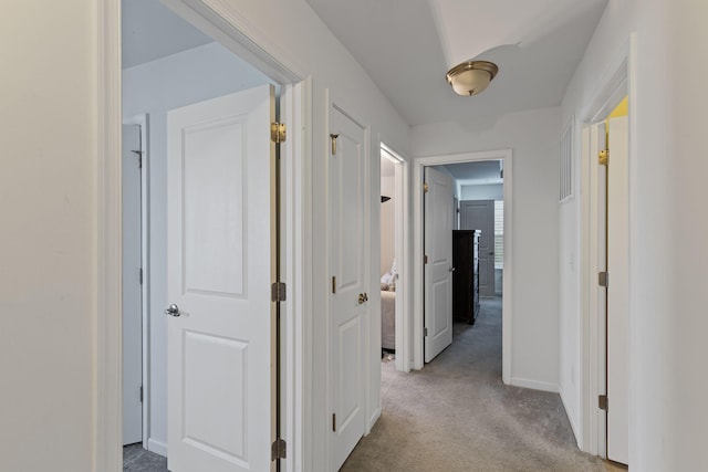 hallway featuring light carpet