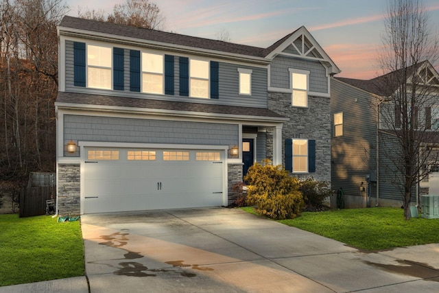 craftsman inspired home featuring a yard and a garage