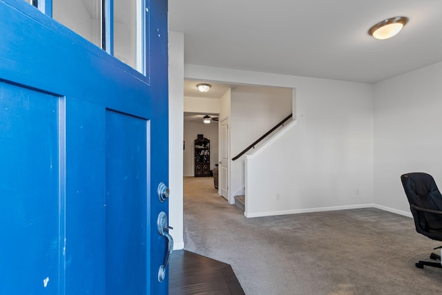 foyer entrance featuring carpet