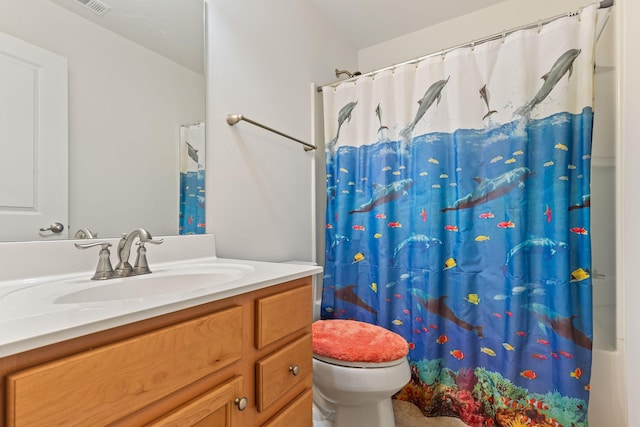 bathroom with vanity, toilet, and walk in shower