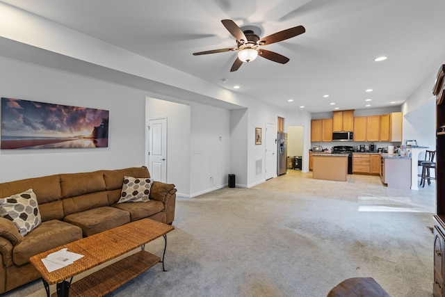 living room with ceiling fan and light colored carpet