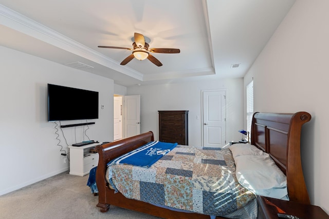 carpeted bedroom with ornamental molding, a raised ceiling, and ceiling fan