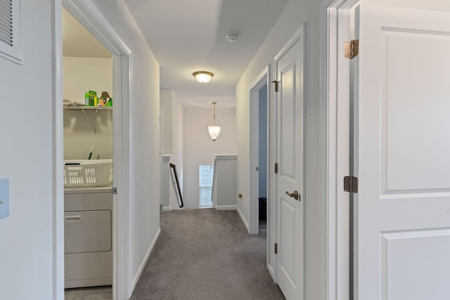 hall featuring washer / clothes dryer and light colored carpet