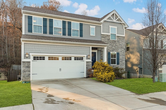 craftsman house featuring a garage and a front lawn