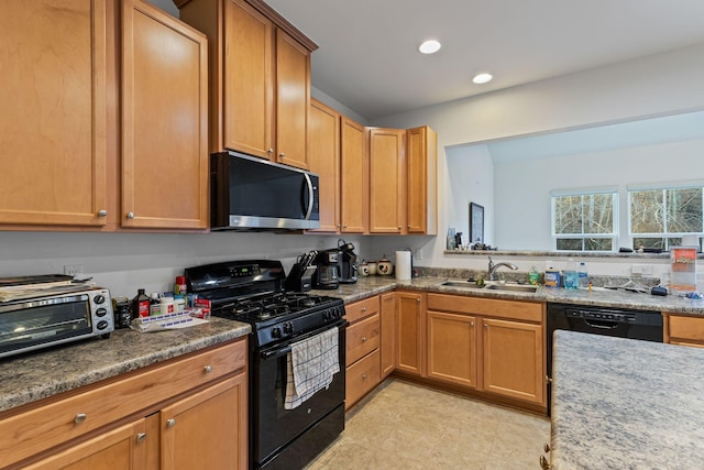 kitchen featuring sink and black appliances