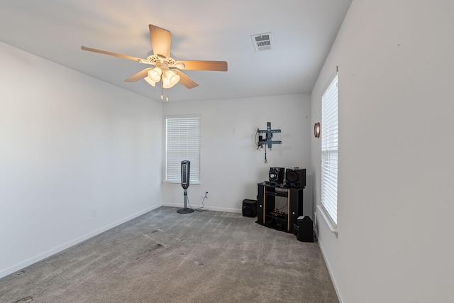 unfurnished room with ceiling fan and light colored carpet