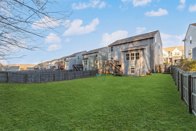 back of house featuring a lawn