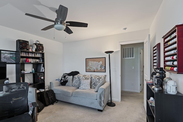 carpeted living room featuring ceiling fan