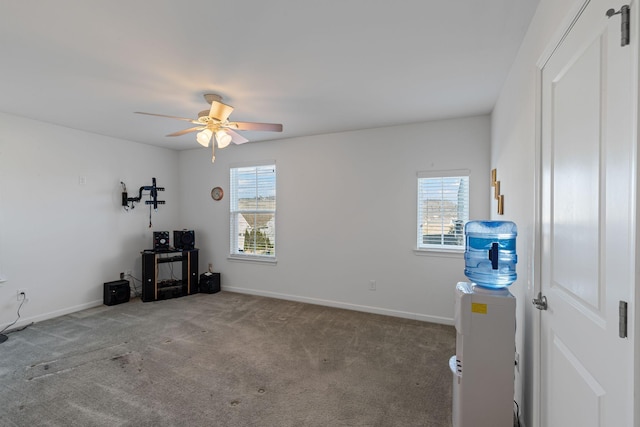 interior space featuring carpet flooring, a wealth of natural light, and ceiling fan