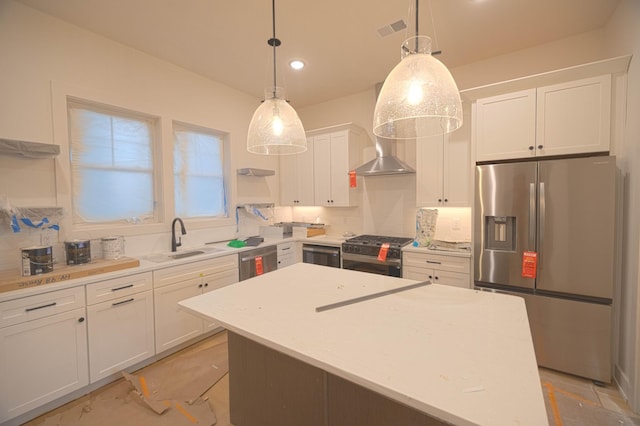 kitchen with white cabinetry, sink, hanging light fixtures, a center island, and stainless steel appliances