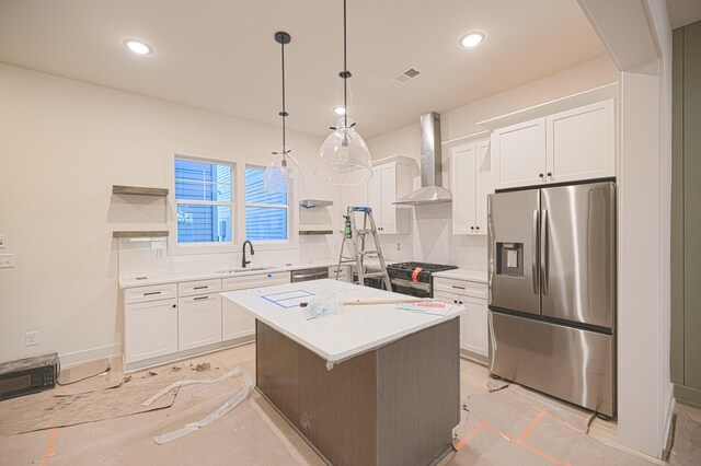 kitchen featuring appliances with stainless steel finishes, a sink, wall chimney exhaust hood, and open shelves