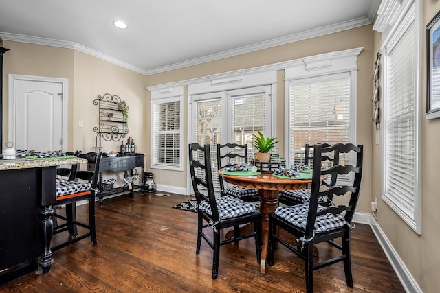 dining space with crown molding and dark hardwood / wood-style floors