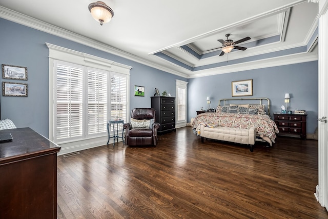 bedroom with a raised ceiling, ornamental molding, dark wood-type flooring, and ceiling fan