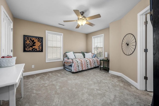 bedroom featuring light carpet and ceiling fan