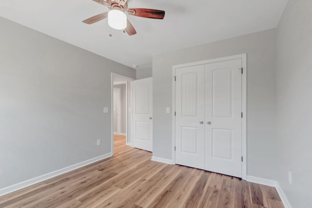 unfurnished bedroom with a closet, ceiling fan, and light wood-type flooring