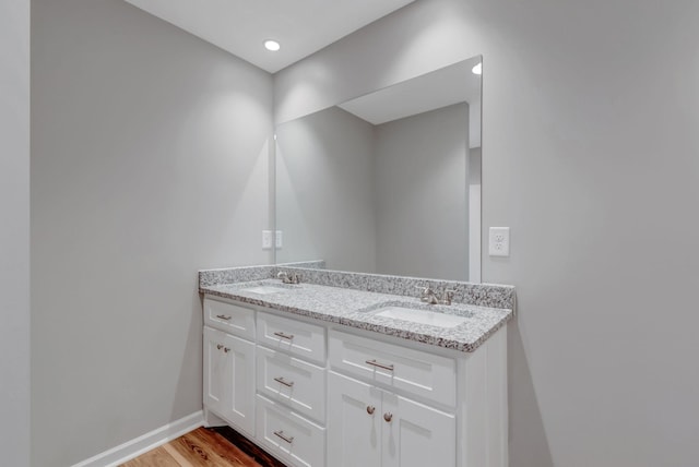 bathroom featuring hardwood / wood-style flooring and vanity