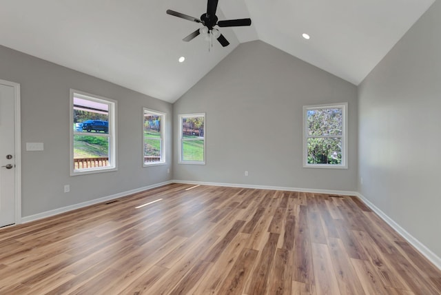 spare room with vaulted ceiling, ceiling fan, and light hardwood / wood-style floors