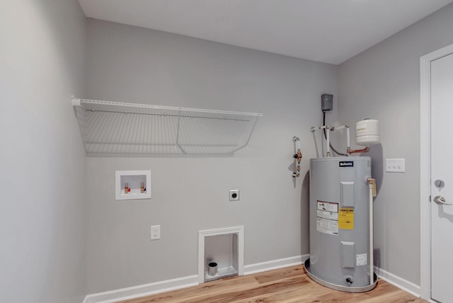 clothes washing area featuring hardwood / wood-style flooring, washer hookup, water heater, and electric dryer hookup