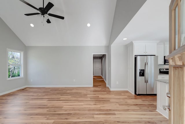 unfurnished living room with ceiling fan, high vaulted ceiling, and light wood-type flooring