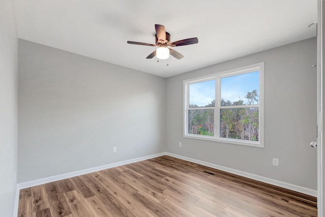 unfurnished room featuring hardwood / wood-style floors and ceiling fan