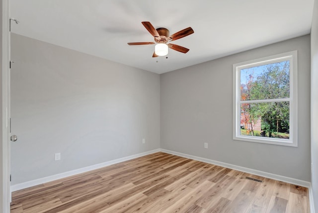 empty room with light hardwood / wood-style floors and ceiling fan