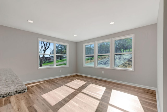 spare room with light hardwood / wood-style floors