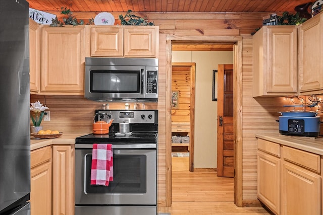 kitchen featuring wooden ceiling, stainless steel appliances, light hardwood / wood-style floors, and light brown cabinets